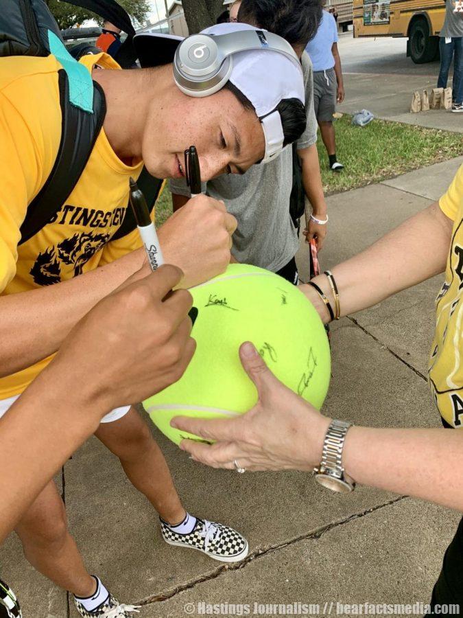 Senior Hieu Phan signs autographs along with his teammates as they head to regionals.