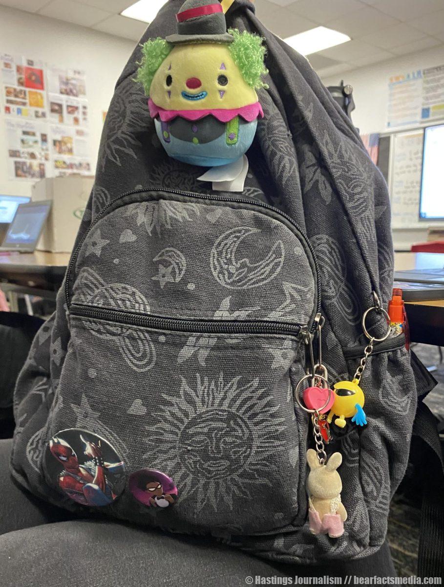 "I like astrology a lot so that's why I got the back pack. I got the clown key chain because I really like clowns. Both my pins are heroes because I'm really into comics and super heroes. I got the Spider Punk from Justin, my favorite person gave me my favorite spider man (this sentence is all Krystal and not edited at all by Justin). I like to collect little like knickknacks so I used some to make the rest of my key chains. Like the heart key chain is actually the lock from one of my old diaries. I also have a guitar because I play the guitar and I have a red car because my dad used to be a mechanic so its sentimental."